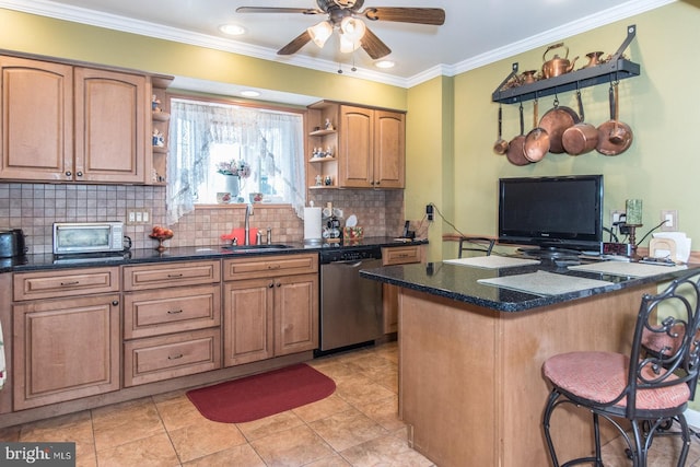 kitchen featuring dishwasher, sink, a kitchen breakfast bar, crown molding, and decorative backsplash