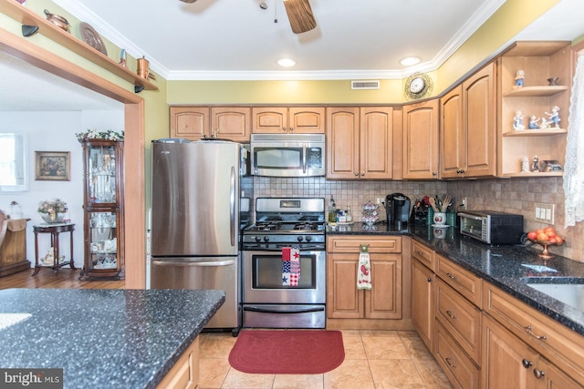 kitchen featuring crown molding, dark stone countertops, light tile patterned floors, tasteful backsplash, and stainless steel appliances