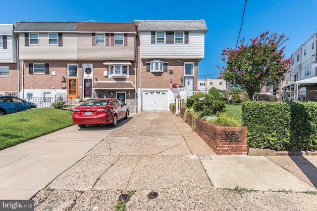 view of front of home with a garage and a front lawn