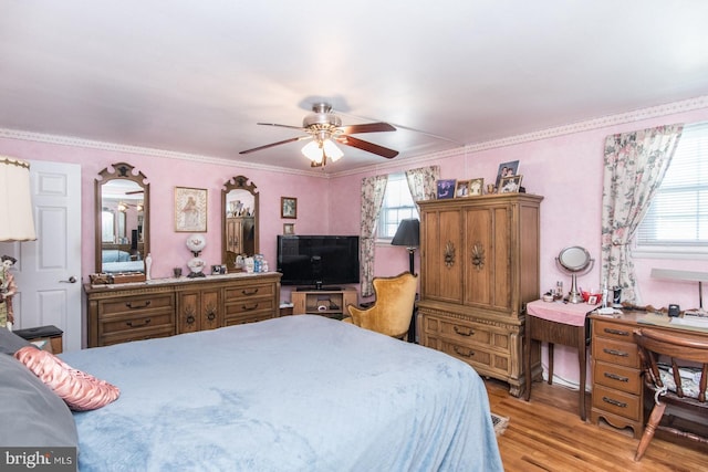 bedroom with ceiling fan, light wood-type flooring, and ornamental molding