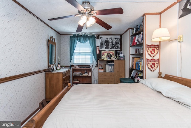 bedroom featuring a textured ceiling, ceiling fan, and crown molding