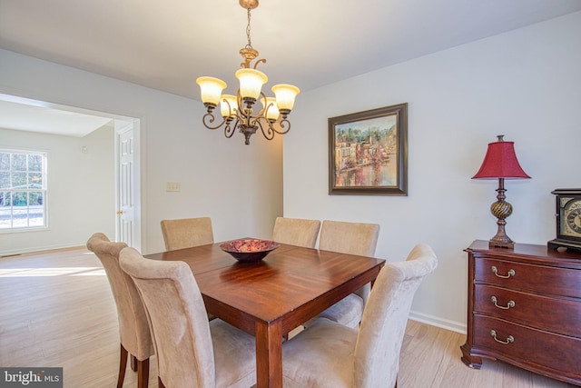 dining room featuring a chandelier and light hardwood / wood-style flooring