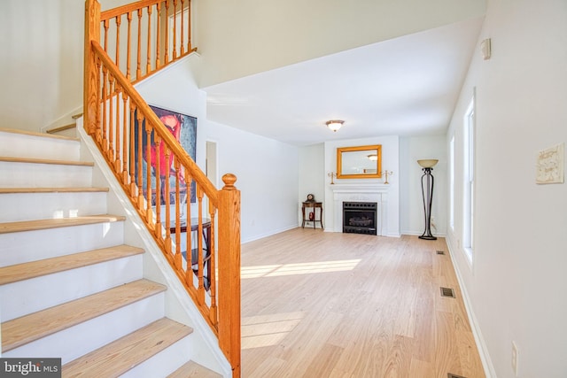 stairs with hardwood / wood-style flooring