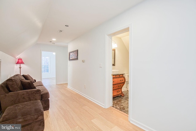 living room with light hardwood / wood-style floors and lofted ceiling