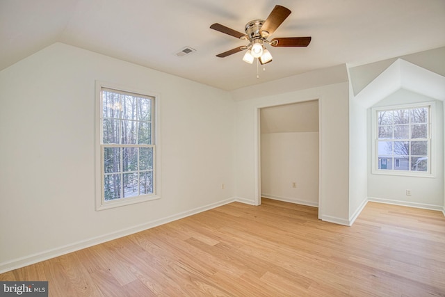 additional living space featuring lofted ceiling, light hardwood / wood-style floors, and ceiling fan