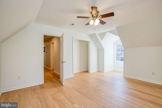 additional living space with ceiling fan, lofted ceiling, and light wood-type flooring