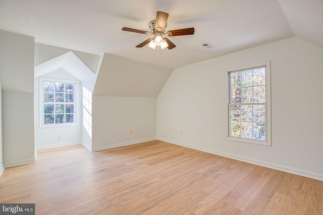 bonus room featuring plenty of natural light, light hardwood / wood-style floors, ceiling fan, and vaulted ceiling