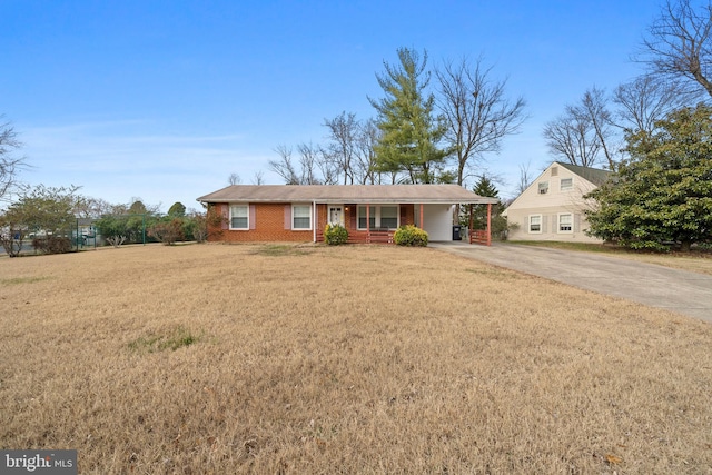 ranch-style house with a carport and a front lawn