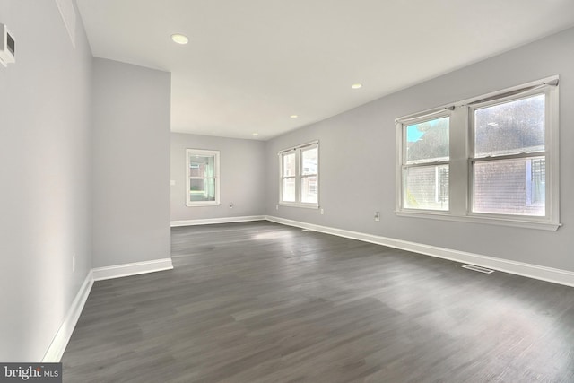 spare room with dark hardwood / wood-style floors