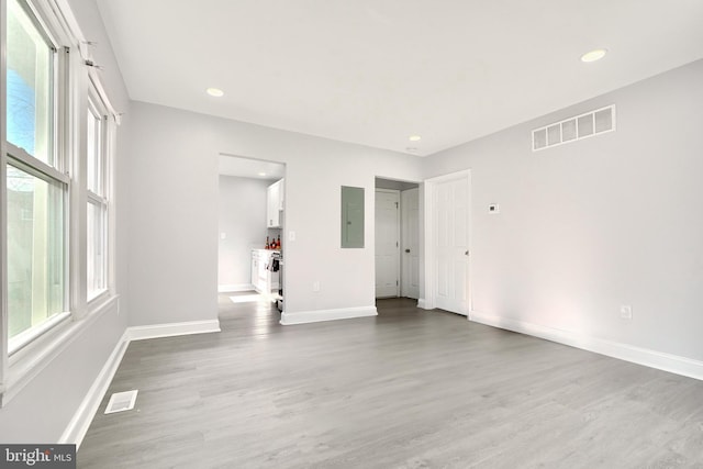 spare room featuring hardwood / wood-style flooring and electric panel