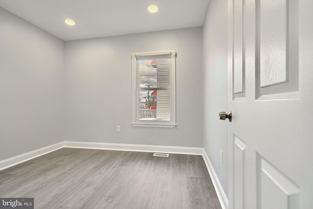 empty room with hardwood / wood-style floors