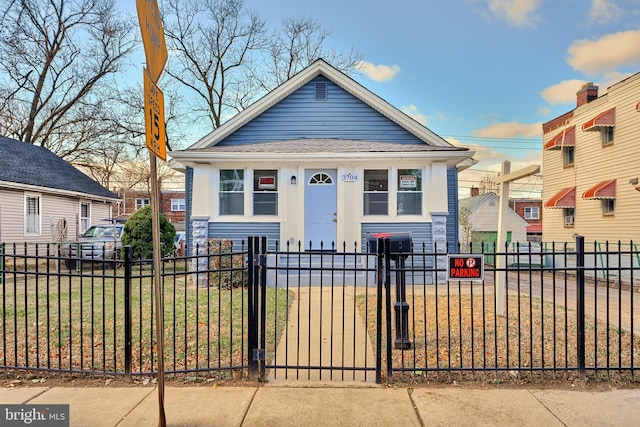 bungalow-style home featuring a front yard