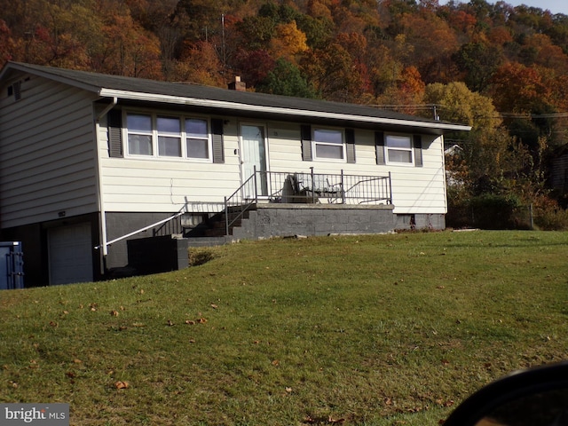 view of front facade with a garage and a front lawn