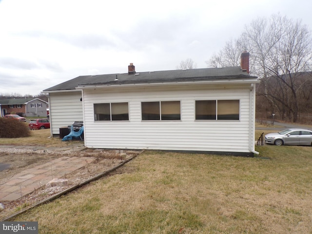 rear view of house with a lawn