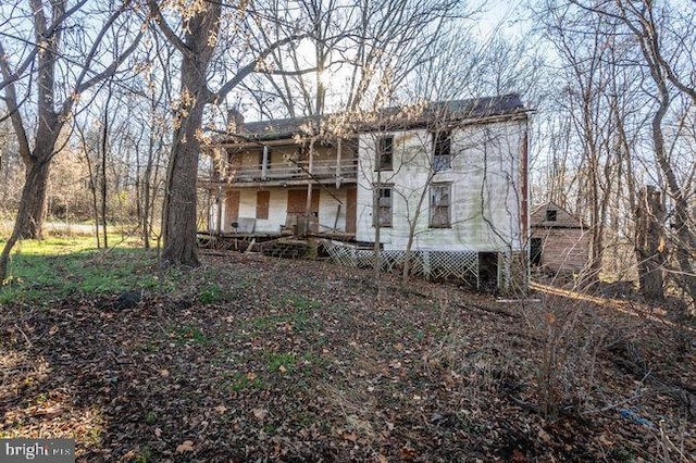 back of property with a balcony