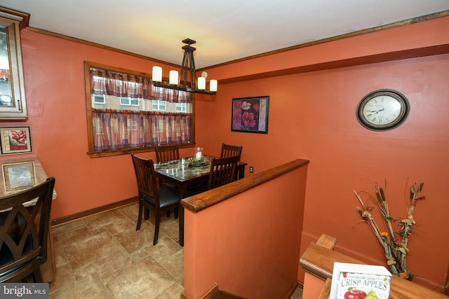 dining space featuring crown molding and an inviting chandelier