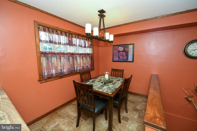 dining room featuring a notable chandelier and ornamental molding