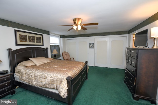 carpeted bedroom with ceiling fan and multiple closets