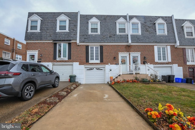 view of front of home with a garage and a front yard