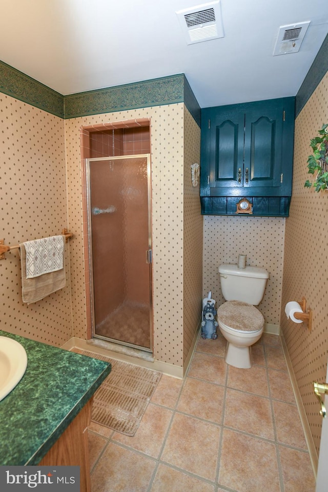 bathroom featuring tile patterned floors, toilet, an enclosed shower, and vanity