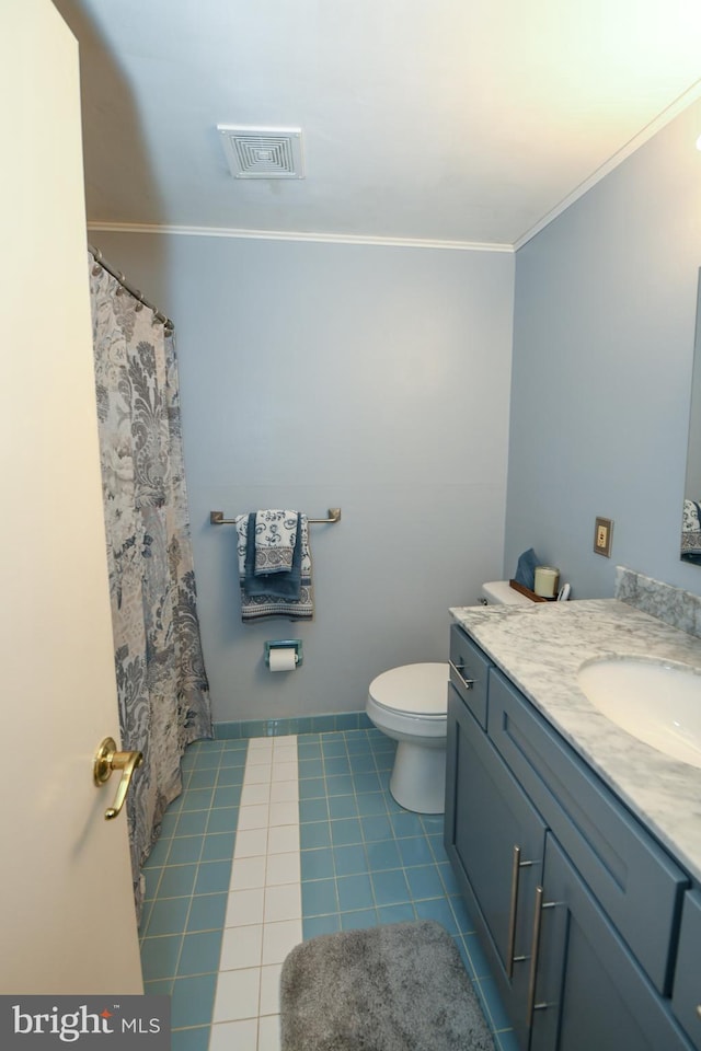 bathroom with tile patterned floors, vanity, toilet, and ornamental molding