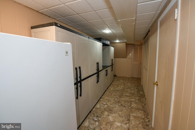 hallway with a paneled ceiling