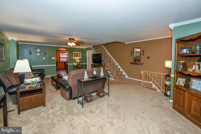 living room with light colored carpet, ceiling fan, and ornamental molding