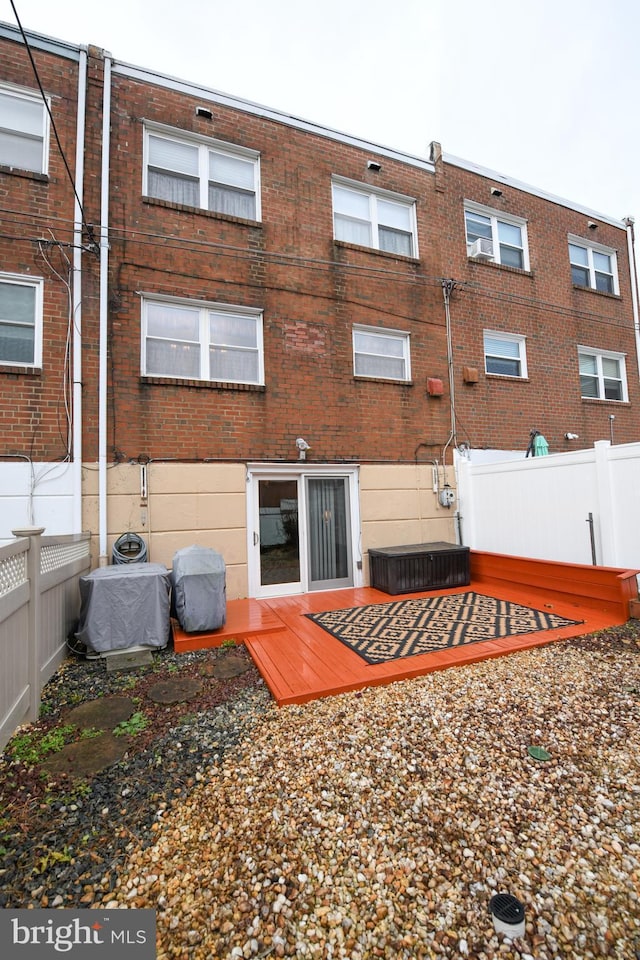 back of property featuring central AC and a deck