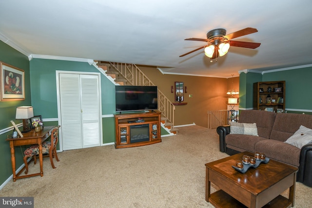 living room featuring carpet, ceiling fan, and ornamental molding