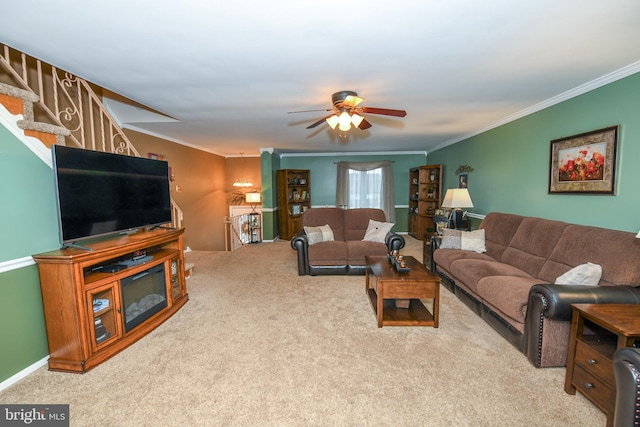 living room with ceiling fan, ornamental molding, and light carpet