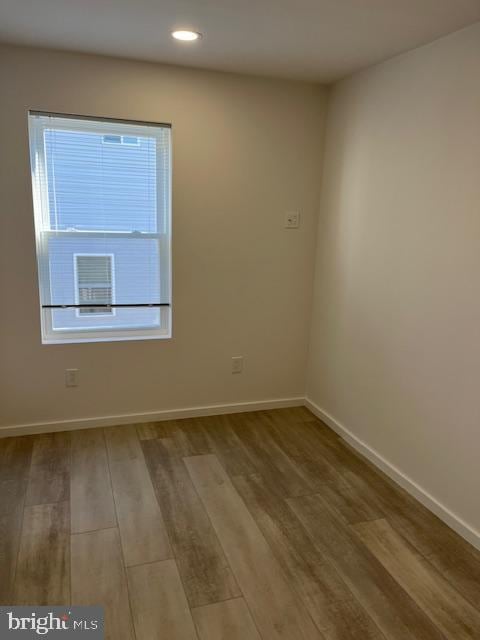 empty room with wood-type flooring