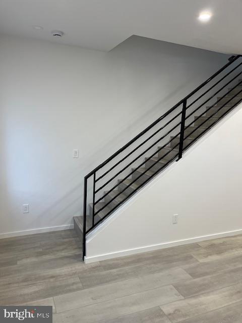 staircase featuring hardwood / wood-style floors