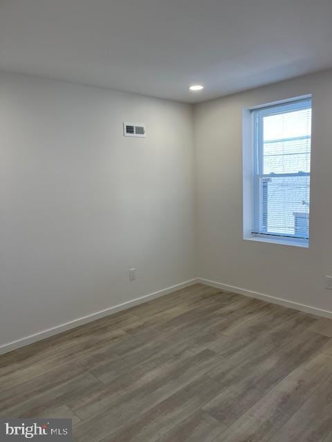 unfurnished room featuring hardwood / wood-style floors