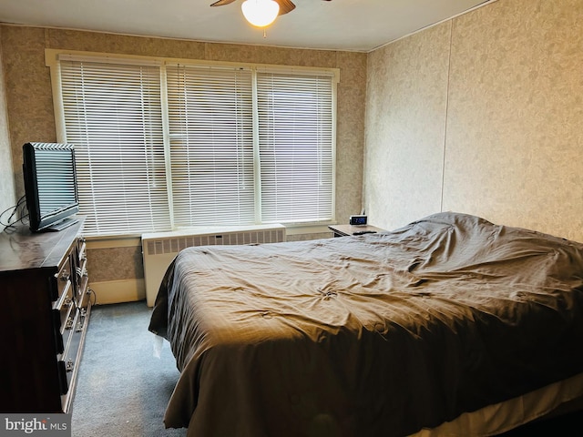 carpeted bedroom featuring radiator and ceiling fan