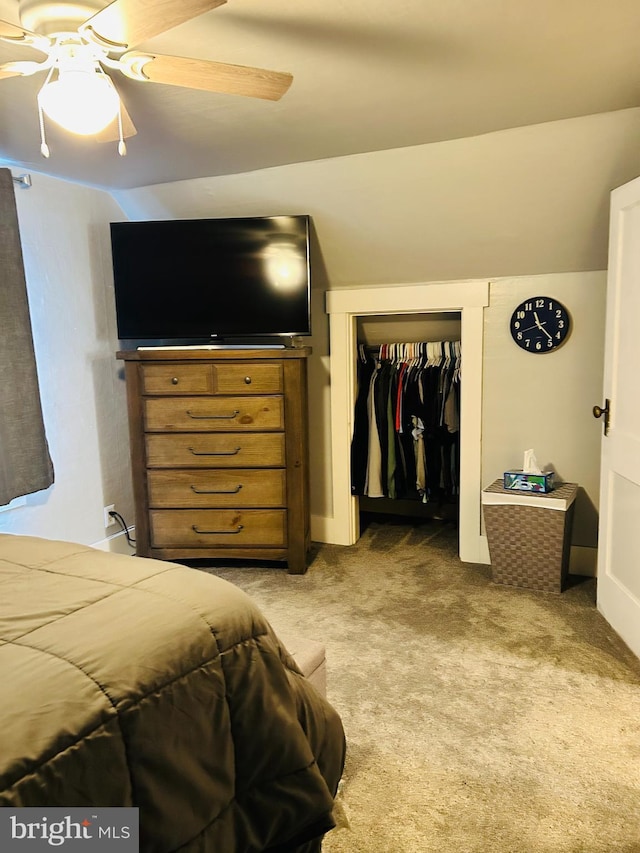 carpeted bedroom featuring ceiling fan, lofted ceiling, and a closet