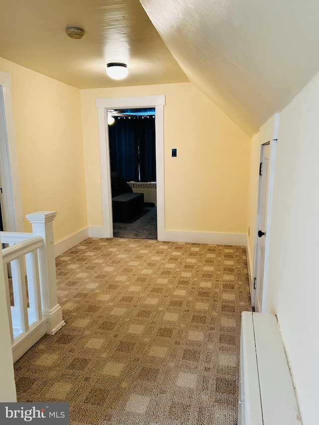 additional living space featuring light carpet and lofted ceiling