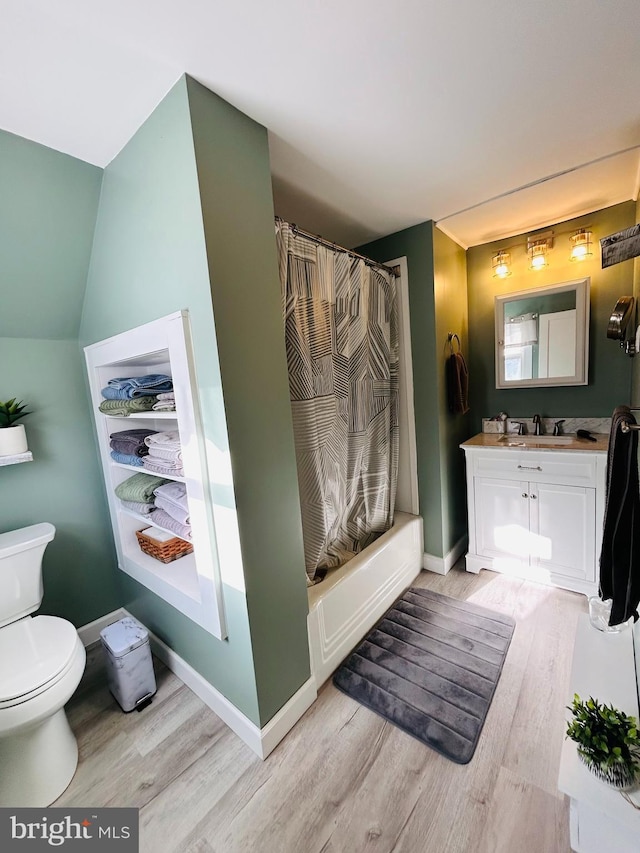 full bathroom with toilet, vanity, shower / bath combination with curtain, and hardwood / wood-style flooring