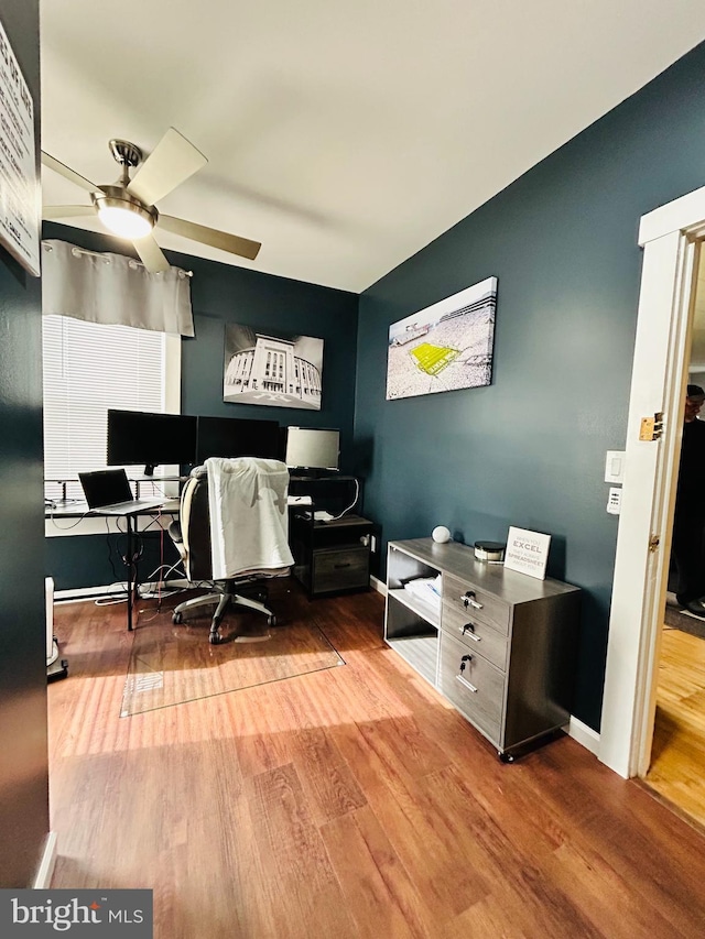 home office featuring hardwood / wood-style floors and ceiling fan