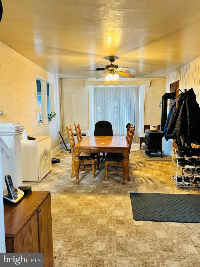 dining space with light colored carpet and ceiling fan