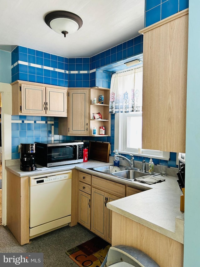 kitchen with light brown cabinetry, decorative backsplash, dishwasher, and sink