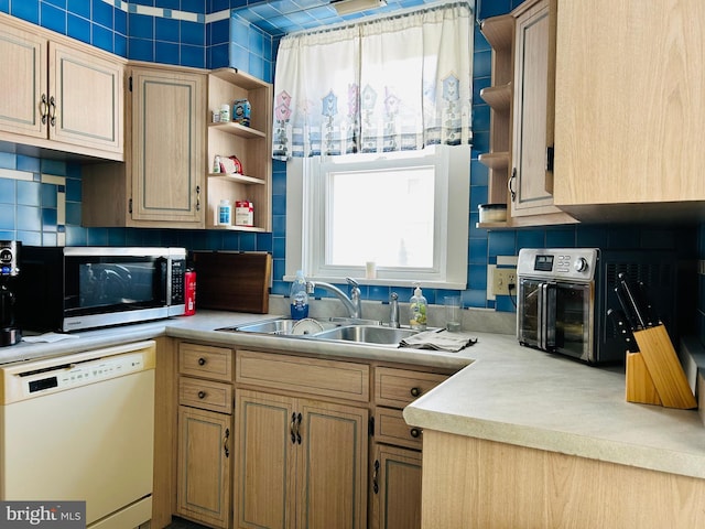 kitchen with light brown cabinets, backsplash, white dishwasher, and sink