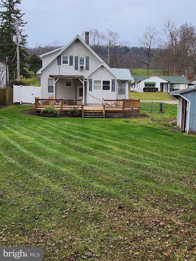 back of house featuring a yard and a deck