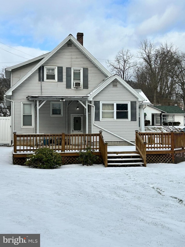 view of snow covered rear of property