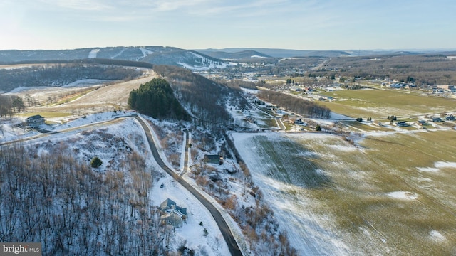 snowy aerial view with a mountain view