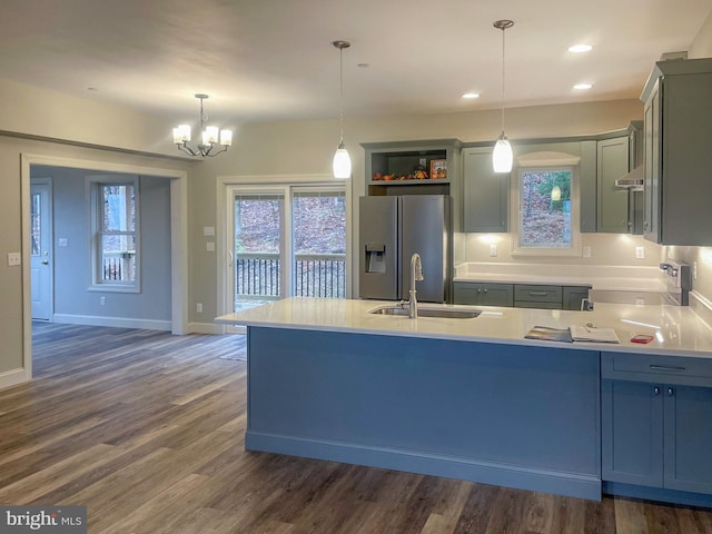 kitchen with pendant lighting, dark hardwood / wood-style flooring, sink, and appliances with stainless steel finishes