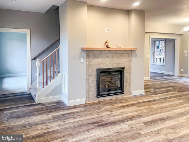 unfurnished living room featuring a fireplace and wood-type flooring