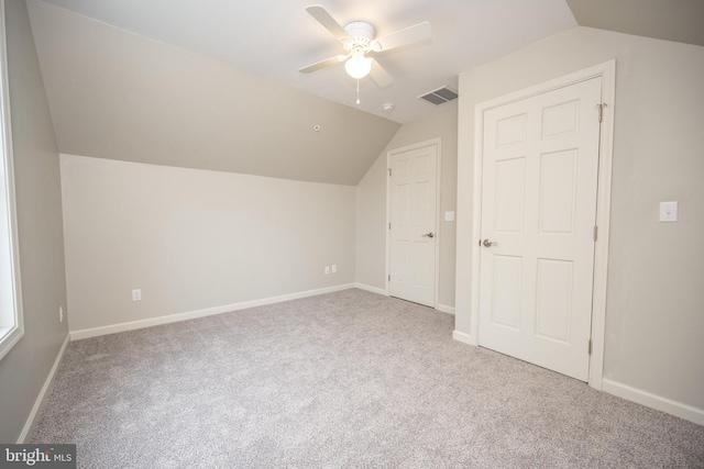 additional living space with carpet floors, vaulted ceiling, and ceiling fan