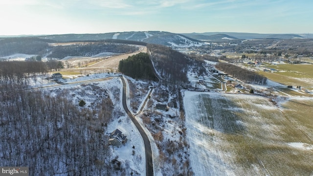 snowy aerial view featuring a mountain view