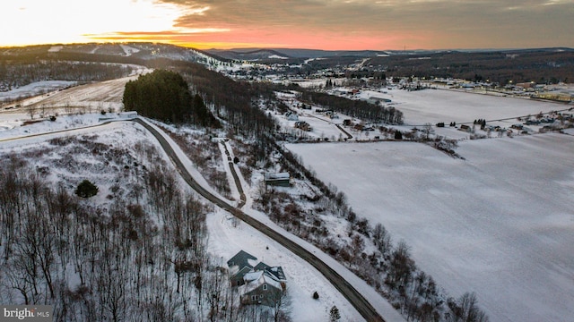 snowy aerial view with a mountain view