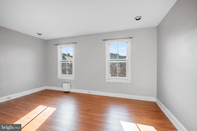 unfurnished room with light wood-type flooring